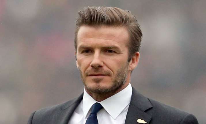 david beckham flaunts toned abs in new ad