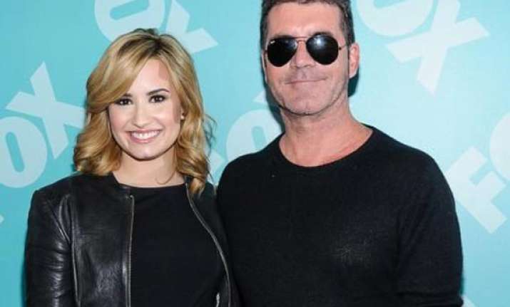 demi lovato finds simon cowell humble