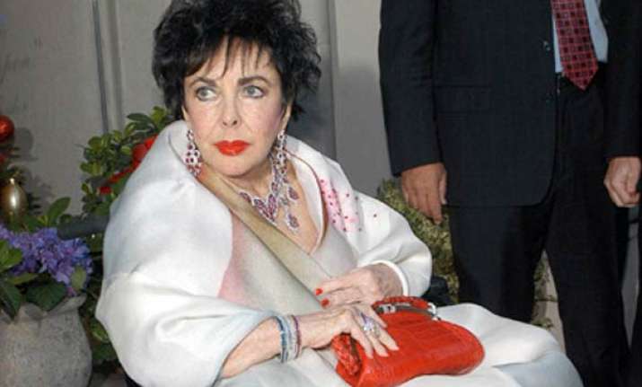 elizabeth taylor improves but remains in hospital