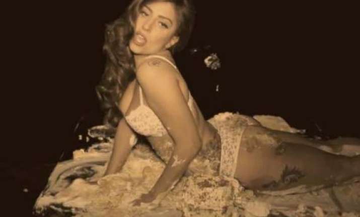 gaga goes semi nude writhes in cake