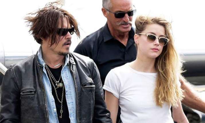 johnny depp s wife amber heard charged with smuggling dogs