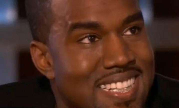rapper kayne west flashes his diamond teeth