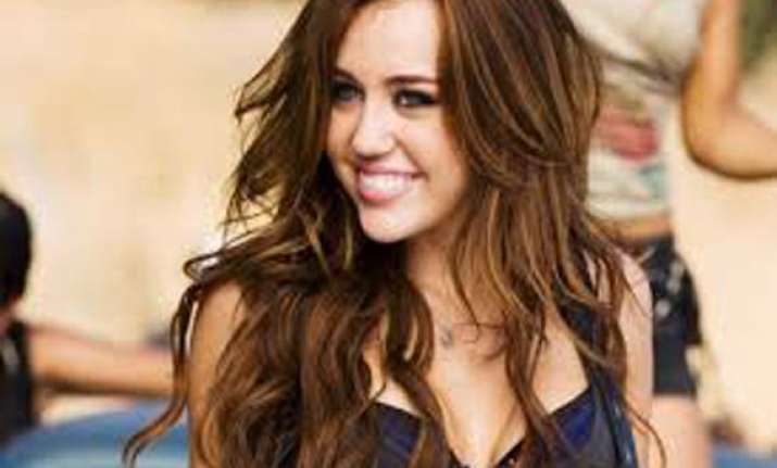 miley cyrus hires fan for assistance