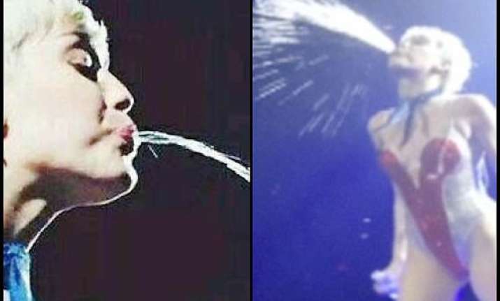 miley cyrus outrageous act spits at audience see pics