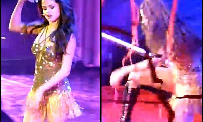oops...selena gomez trips off stage while performing see