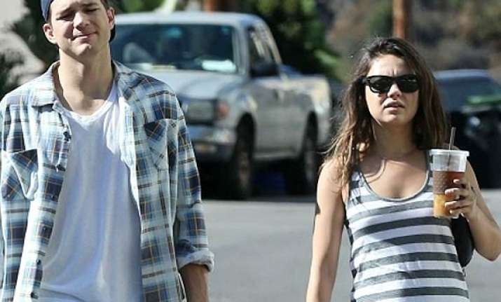 mila kunis shows baby bump
