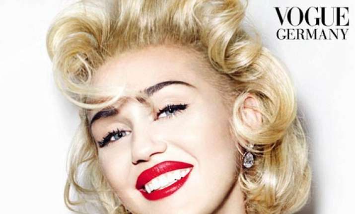 miley cyrus goes topless poses with two men in bed see pics