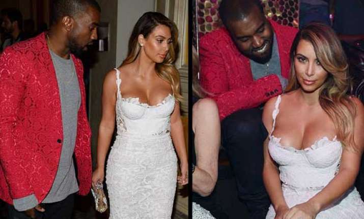 rapper kayne west can t keep her eyes off kim s cleavage