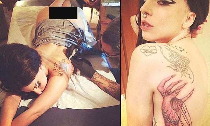 lady gaga bares her derriere while getting inked for the