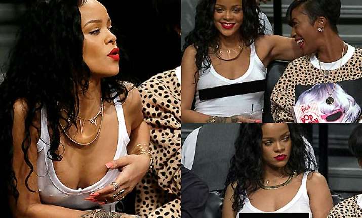outrageous rihanna goes bra less in a white see through top