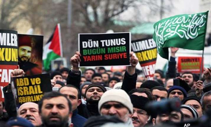 at least 7 killed as thousands defy assad in syria