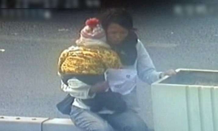 cctv footage of chinese cop saving woman kid trying to jump
