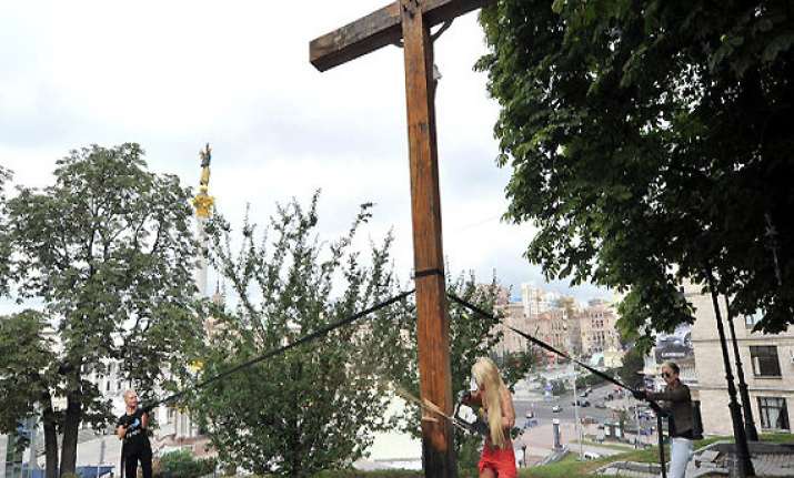 cross chopping topless activist flees ukraine