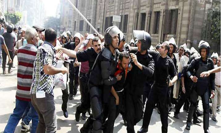 egyptian riot police fire tear gas at protesters