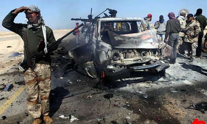 gaddafi onslaught pushes rebels back from brega