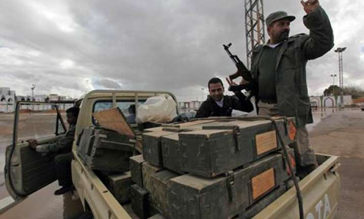gaddafi supporters blow up arms caches rebels capture oil