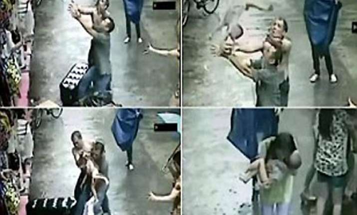 heart stopping moment chinese men catch baby falling from