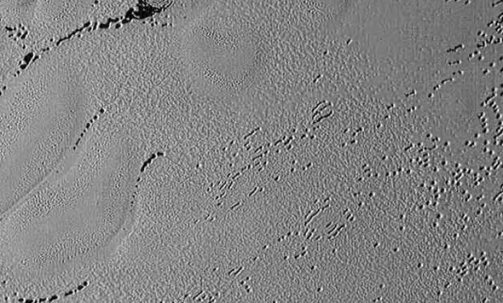 new image shows pluto s puzzling patterns pits