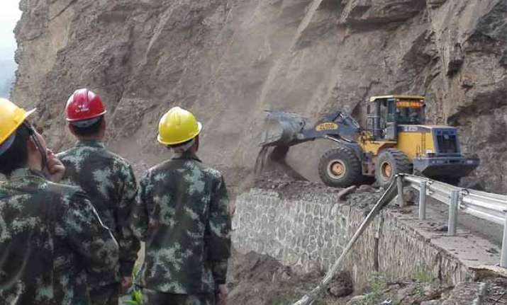 chinese soldiers repair highway in nepal