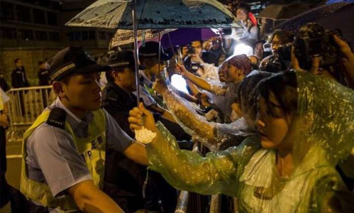 china backs hk leader as pressure to quit grows
