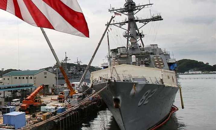 china warns us navy after ship sails by chinese built island