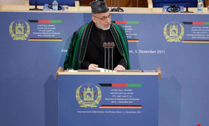 karzai will try to hold on to power beyond 2014 report
