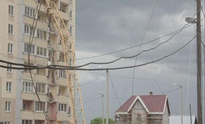 large crane collapses on apartment building in russia