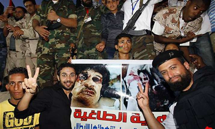 libya declared free but gadhafi death questioned