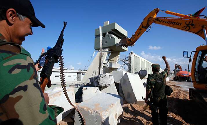 libyans tearing down gadhafi s tripoli compound
