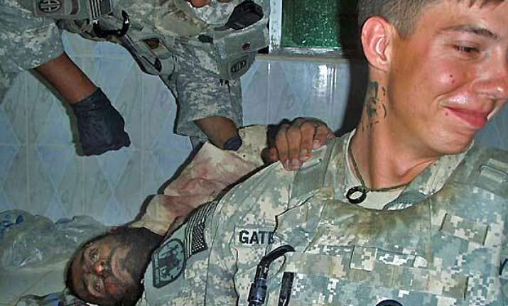 outrage as us soldiers pose with severed bodies of taliban