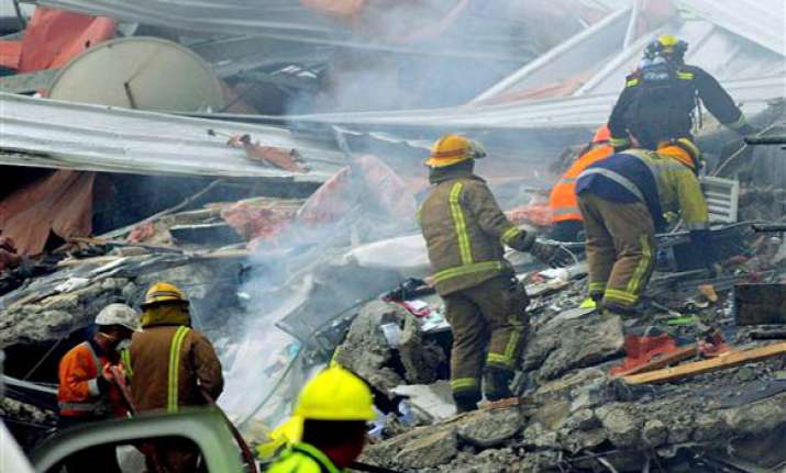 rescuers in nz pull out more dead from debris toll goes up