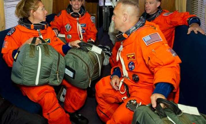 shuttle astronauts busy with space station stockpiling