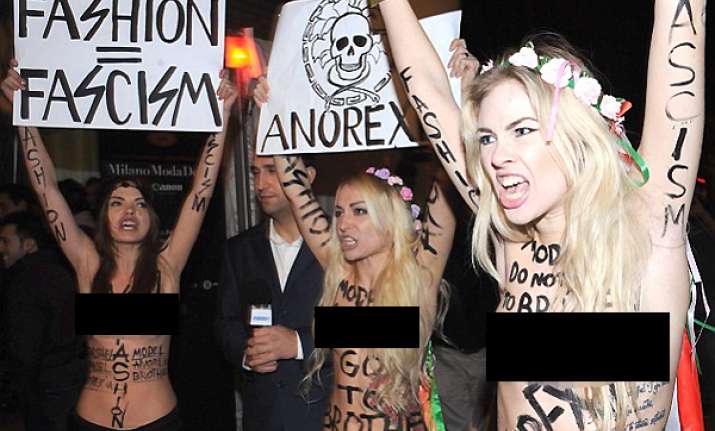 topless protesters crash milan fashion week in demo against