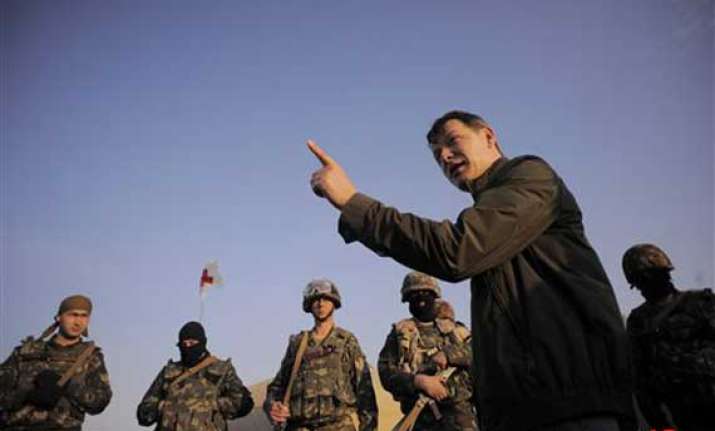 ukraine defense chief resigns troops leave crimea