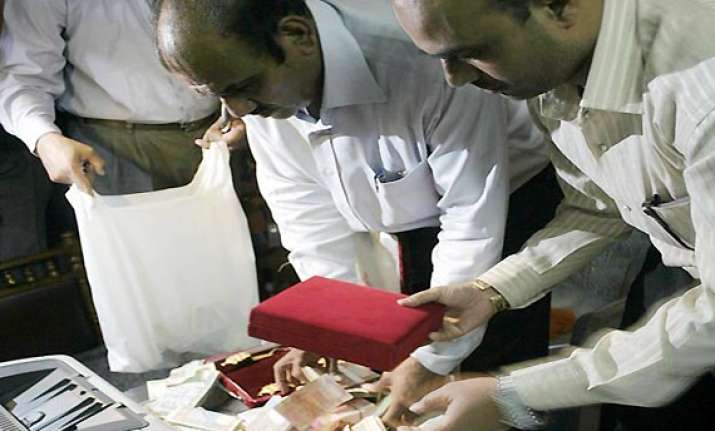 2 kg gold rs 14 lakh cash seized from asst commissioner