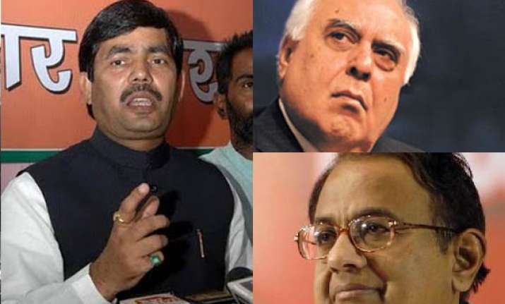 bjp asks pm to remove chidambaram sibal