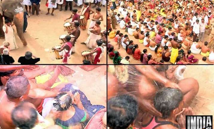bizarre priest breaks coconuts on heads of karur temple