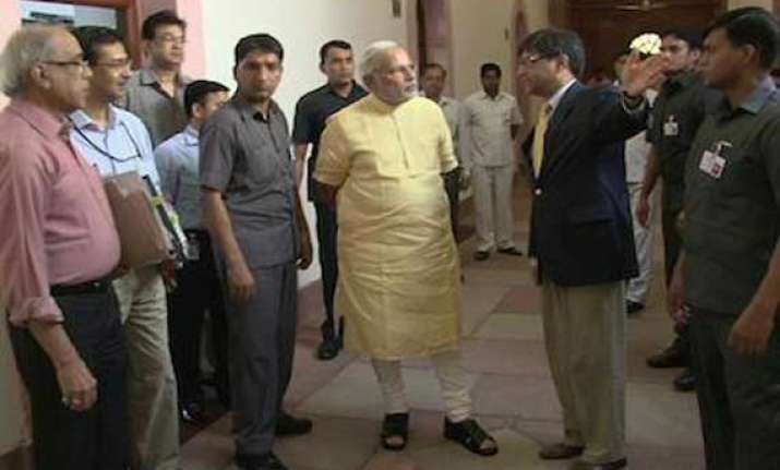 narendra modi walks through pmo posts picture