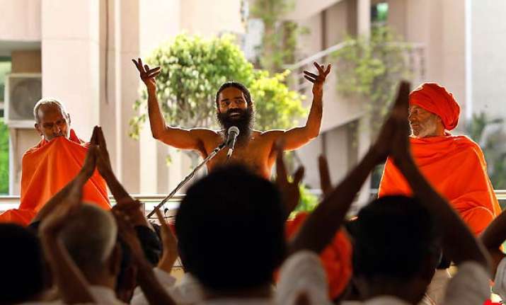 ramdev forgives pm cong accuses him of being rss agent