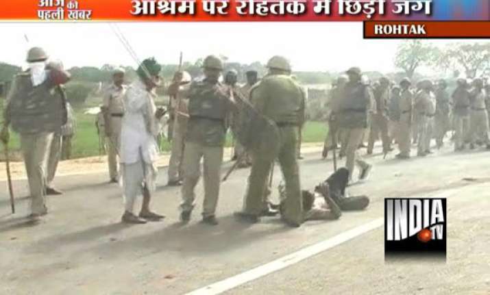 3 killed over 100 injured in rohtak firing crpf raf deployed