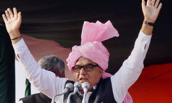 hooda challenges modi to a debate on development