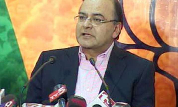 bjp criticises pm for defending raja in spectrum scam