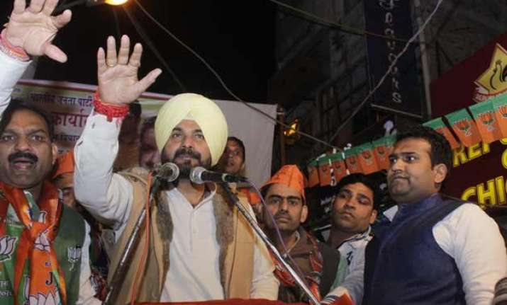 delhi polls on campaign trail for bjp sidhu pushes buy one