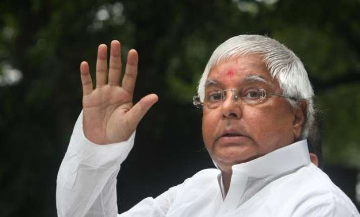 lalu s close aide helping him wear shoes kick off row