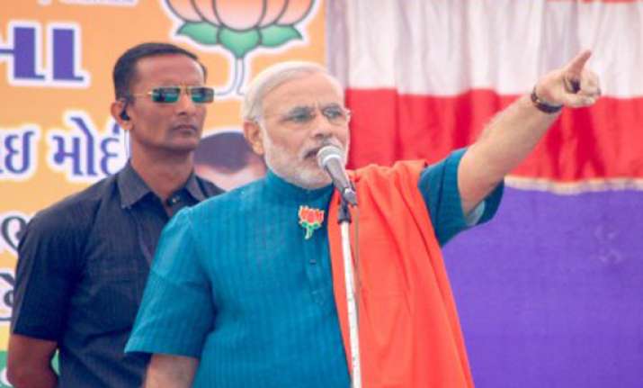 narendra modi unveils bjp s gujarat manifesto