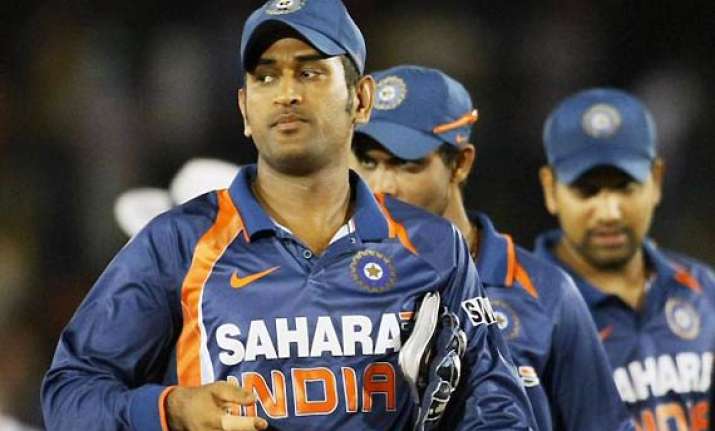 modest dhoni leads by example for expectant india