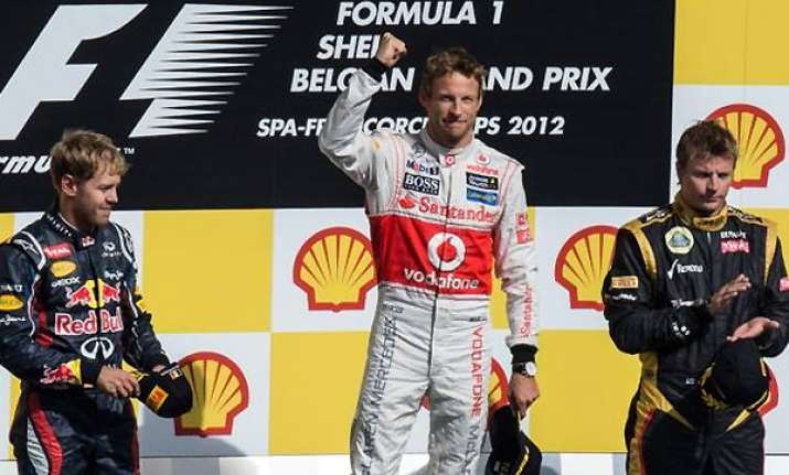 button wins crash marred belgian gp