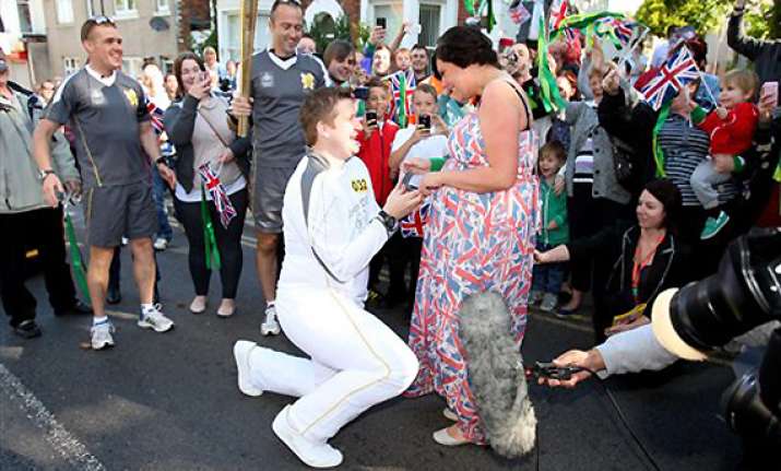 olympic torch bearer proposes during relay