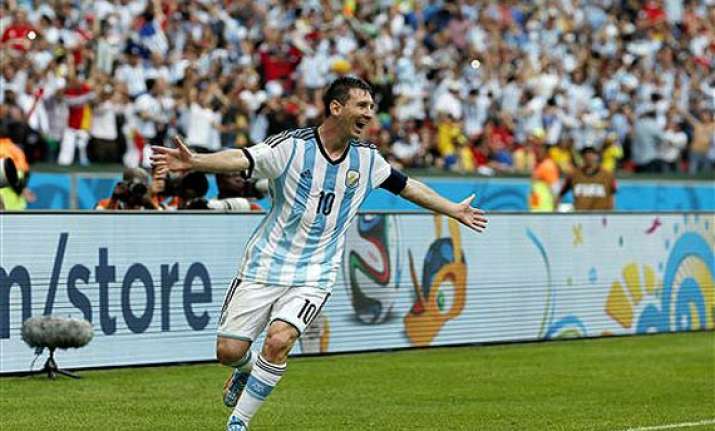 fifa world cup messi magic helps argentina top group
