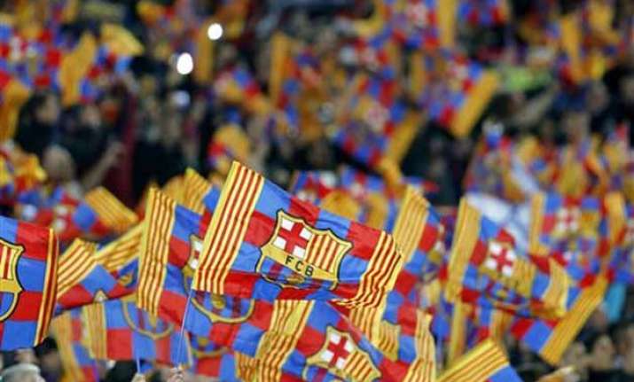 uefa charges barcelona over fan banner at man city match